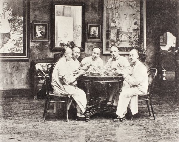 Men posed in the Yao Hua Studio, Shanghai, with enlarged photographs of courtesans