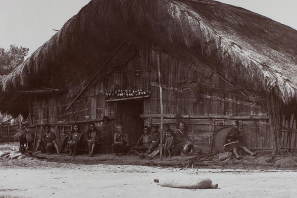 Aborigines sitting in front of house, Tsui-sia, Formosa