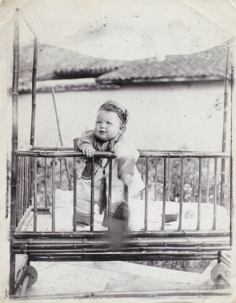 Dare Elliott aged nine months, in bamboo cot, 1909