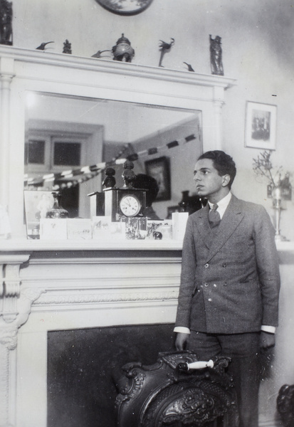 Flashlight photograph of Frank Abraham in front of a fireplace