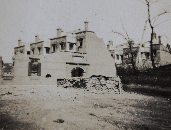 Sandbagged guard post and war damaged buildings, Shanghai, 1932