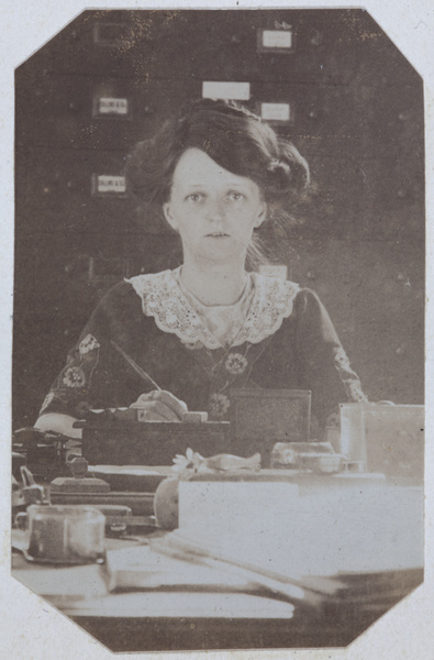 Edith Chappel writing at a desk, Tianjin