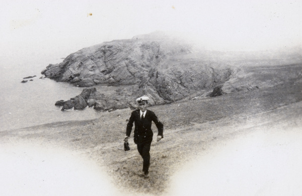 F. Hagger walking by the coast