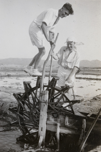 Royal Navy sailors pretending to work a waterwheel