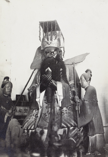 Shrine figure wearing a mian liu hat, and two smaller female figures with fans