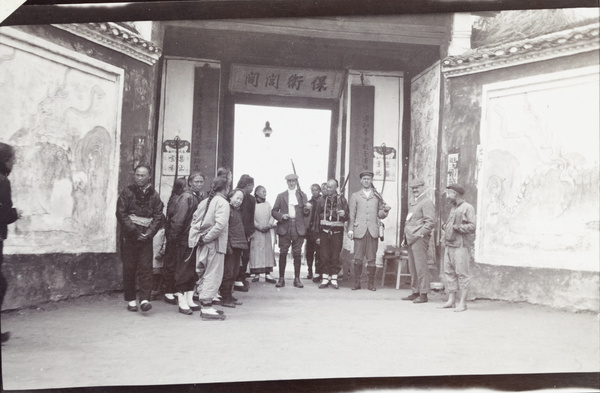 Chinese and European men at the doorway to Chinese Barracks, Shanghai