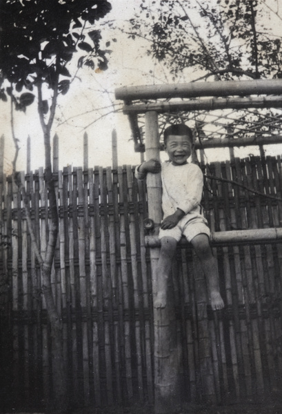 Fred Hutchinson sitting on a bamboo garden frame, 35 Tongshan Road, Hongkou, Shanghai
