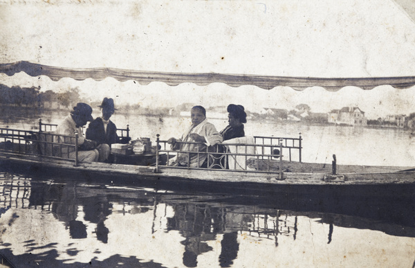 Two Japanese women and two men taking tea on a boat, West Lake, Hangzhou