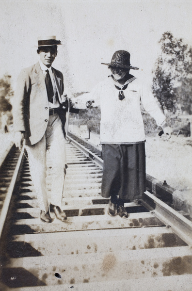 Bill Hutchinson walking with Hannah along a railway track, Shanghai