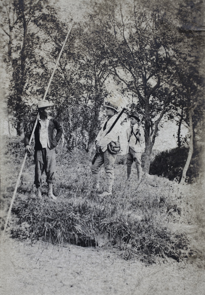 Man with a long bamboo pole, Charles Hutchinson and John Piry with hunting rifles, Shanghai