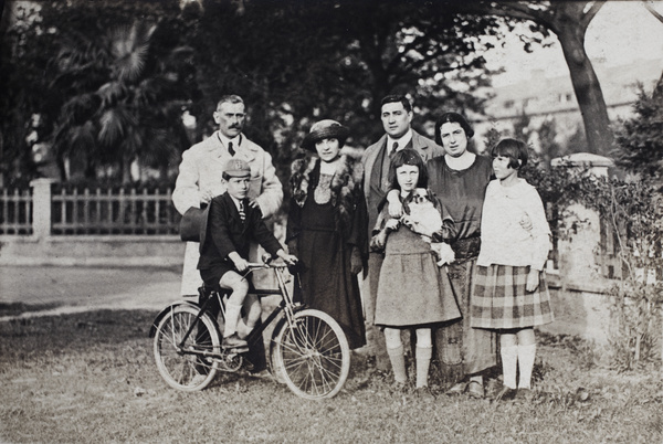 Charles and Margie Hutchinson with the Hansen family, pet dog, and 'Baba' on his bicycle, Route Doumer (Donghu Lu), Shanghai