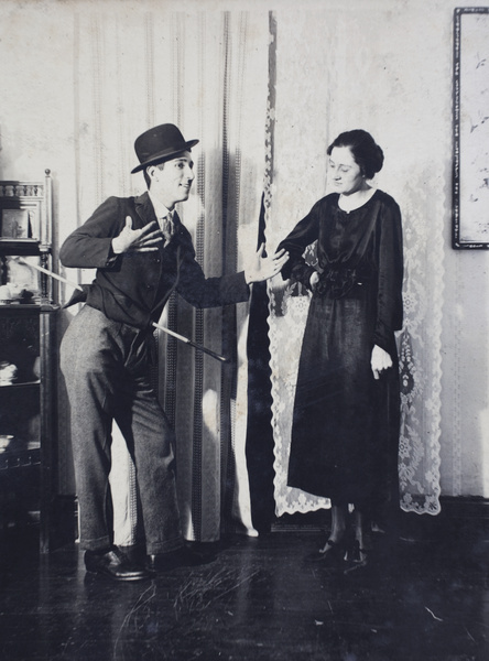 John Henderson impersonating Charlie Chaplin with an unidentified woman at a house party, 35 Tongshan Road, Hongkou, Shanghai