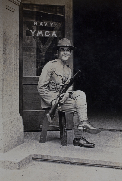 Mr Atiyeh, American Company Shanghai Volunteer Corps member, on duty at the entrance to the Navy YMCA, Shanghai, 1925