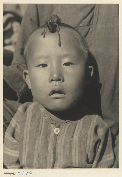 Boy from the 'Lost Tribe' country with topknot