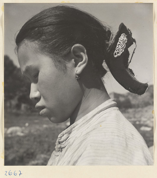 Woman wearing a silver hair ornament with blue inlay work in the Lost Tribe country