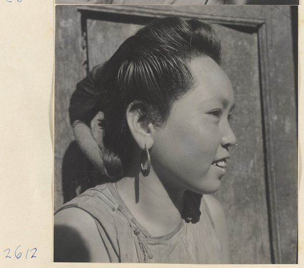 Woman with teapot hairstyle and hoop earrings in the Lost Tribe country