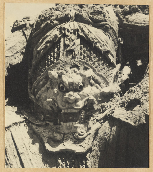 Detail showing a dragon head on the torso of a celestial king outside Luohan tang at Chengde