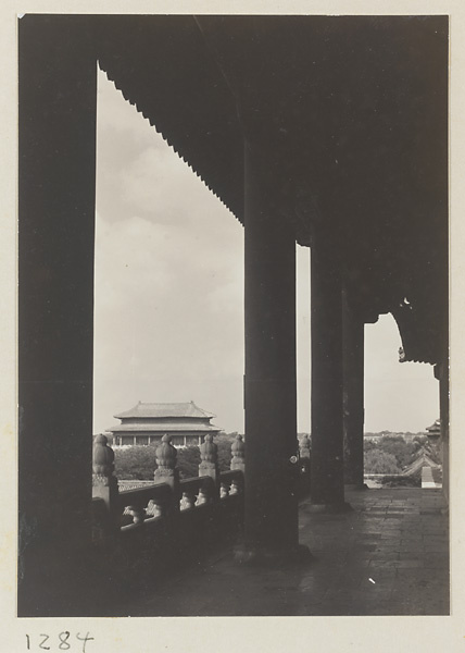 Columnaded porch with view of a double-eaved building in the Forbidden City
