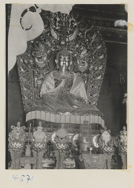 Interior of temple building at Yong he gong showing an altar with a Buddha figure