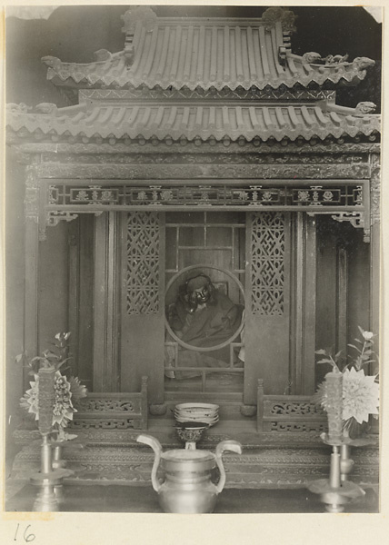 Altar in the form of a pavillion with lattice work and draped statue at Xi yu si