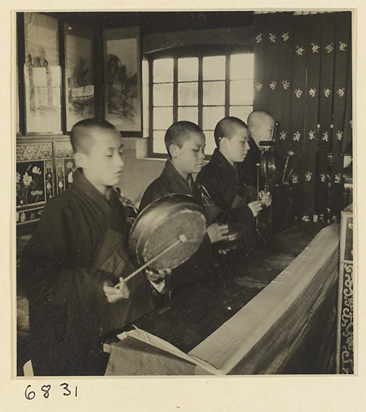 Buddhist nuns playing musical instruments during service