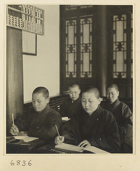 Buddhist nuns writing at desks