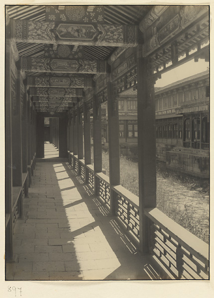 Interior view of covered walkway at Nanhai Gong Yuan showing painted rafters