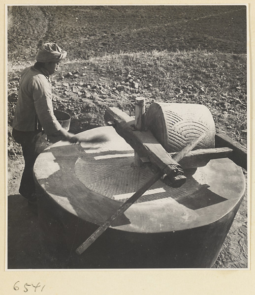 Man brushing the surface of a grindstone