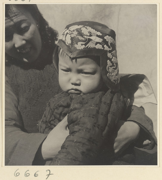 Woman and child wearing an embroidered hat