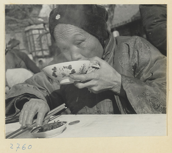 Woman eating at food vendor's stand