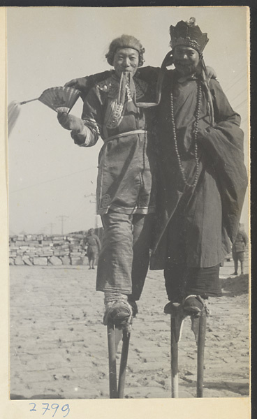 Costumed soldiers walking on stilts at New Year's