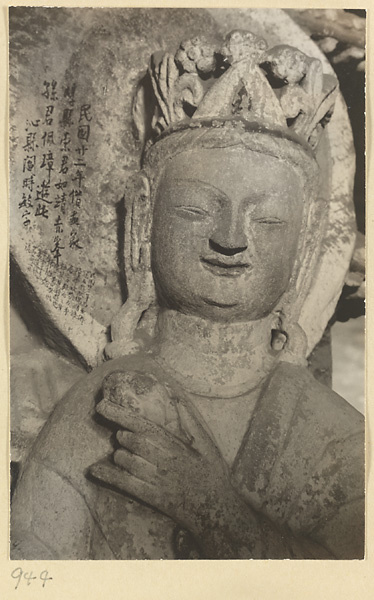 Detail showing the head of a statue of a Bodhisattva with grafitti at the Yun'gang Caves