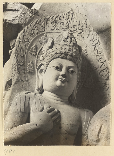 Detail showing the head and arm of a statue of a Bodhisattva at the Yun'gang Caves
