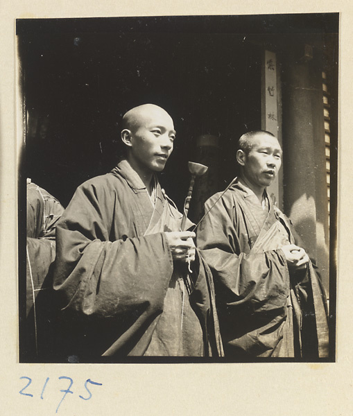 Monks with handchime standing at temple entrance on Miaofeng Mountain