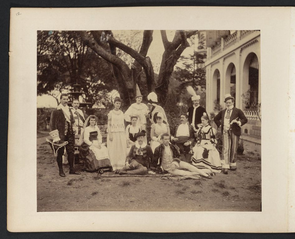 Group of people dressed for costume party, posing under tree, Canton