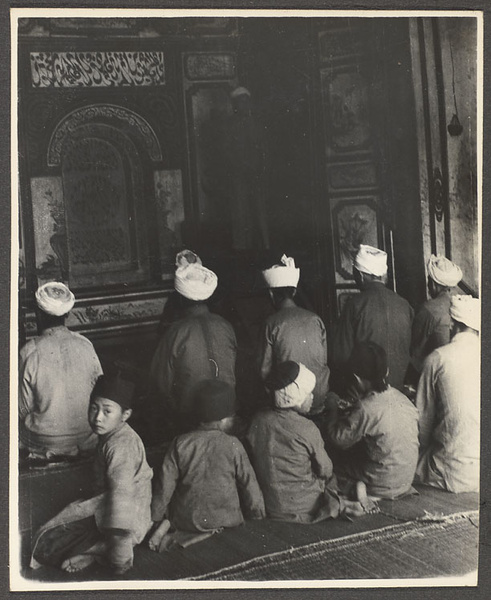 Men and boys praying in a mosque