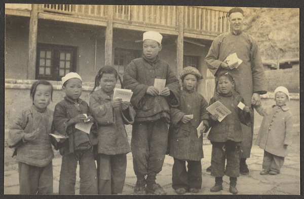 Mr. Learner, his child, and Muslim school children holding Christian tracts in Xining