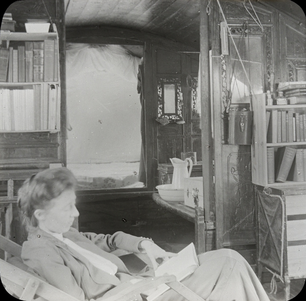 Woman reading inside a houseboat