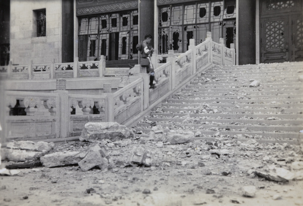A boy scout photographing war damage at Greater Shanghai Municipality Civic Centre, Jiangwan, Shanghai