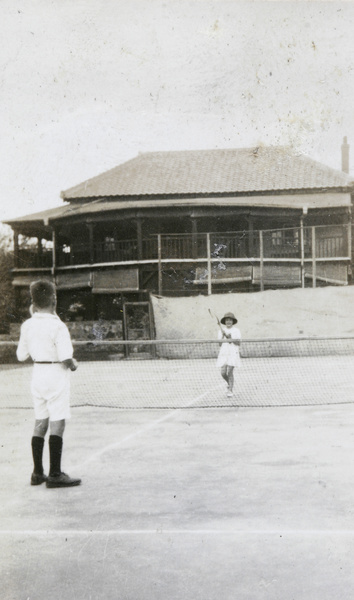 Boy and girl playing tennis