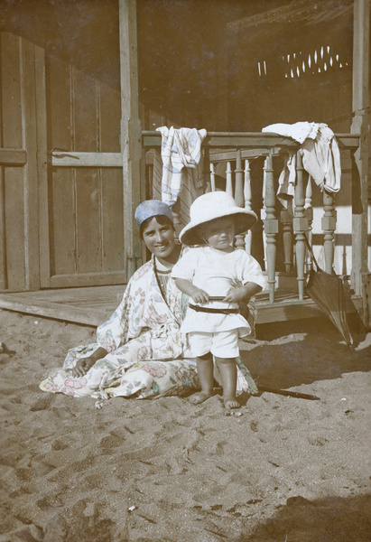 Geraldine Johns with son Gerald beside a beach hut