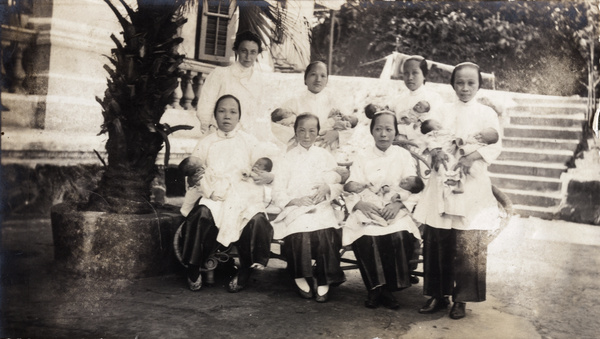Dr Eleanor Whitworth Mitchell with nurses and newly born babies, outside a maternity hospital, Hong Kong