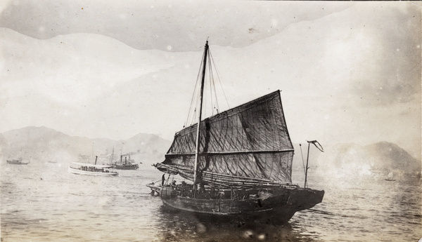 A boat with a half raised sail, and other shipping, Hong Kong