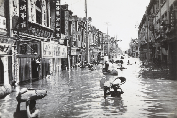 Pedestrians wading through flood water, Tianjin, September 1938