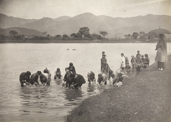 Girls' school pupils washing clothes in the river, Yongchun
