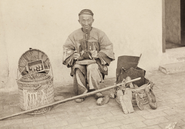 A shoe mender with tools and travelling pack