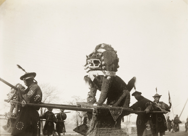 Bearers carrying paper lions in a funeral procession, Beijing