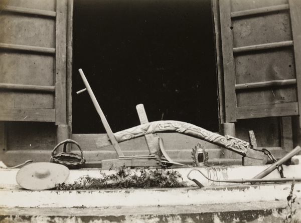 A ceremonial plough, with other farm tools