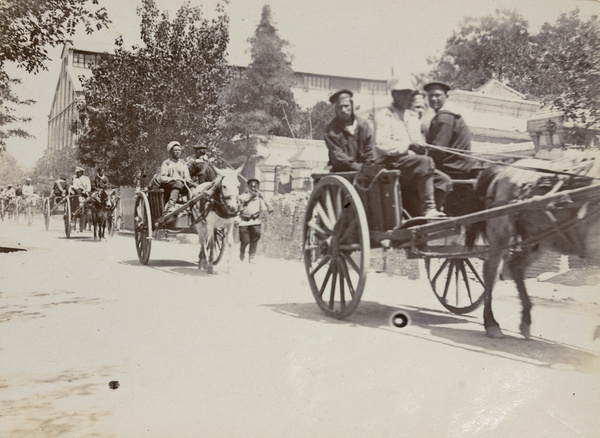 Russian military carts passing William Forbes & Co's godown, Victoria Road, Tianjin, 1900 