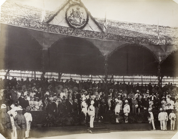 Spectators and dignitaries under a pavilion during the commemoration of Queen Victoria's Diamond Jubilee, Hong Kong, 1897
